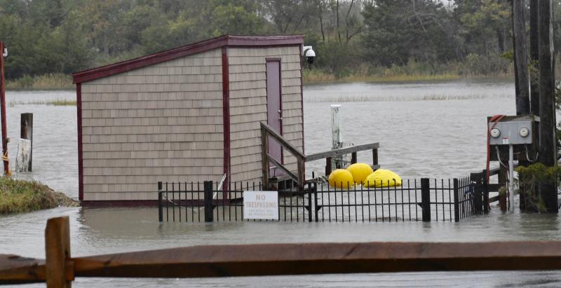 Several boathouses along Pilottown Road in Lewes are surrounded by water from the canal. RON MACARTHUR PHOTO