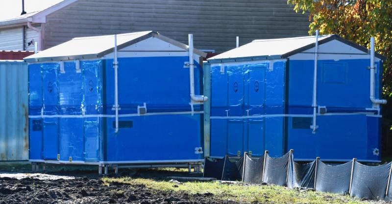 Two prefabricated bathroom/shower units are ready to be moved to the village and hooked into water and sewer systems.