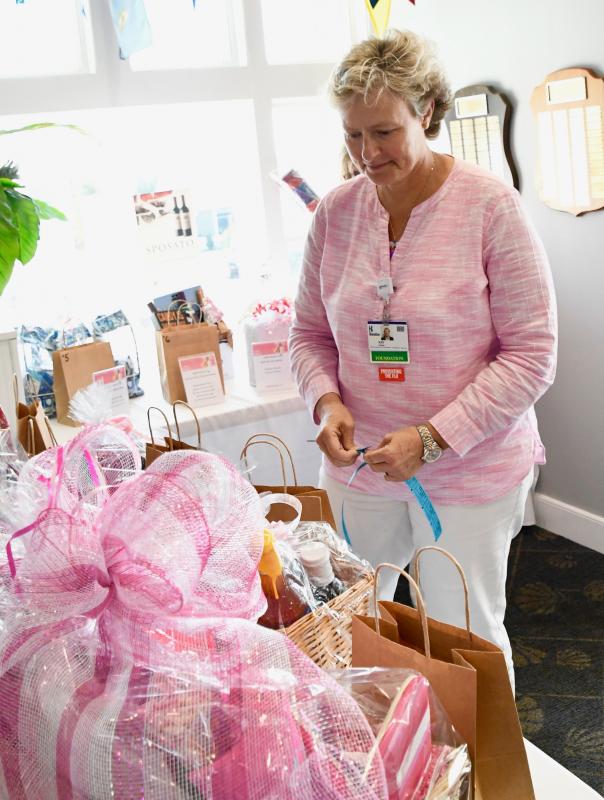 Kay Young, Beebe Medical Foundation executive director of development, tries to decide which basket she wants to place her raffle tickets in.