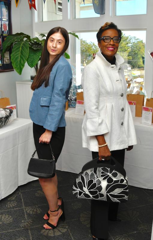2022 Miss Lewes Teen USA Makenna Krajewski, left, and Marjorie Biles, a staff member, prepare to walk the floor in clothes available at the event’s boutique.
