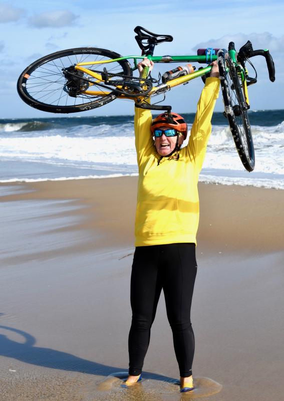 “I did it,” says Cindy Norris after getting off her bike to touch the Atlantic Ocean after more than three months on the roads of America.