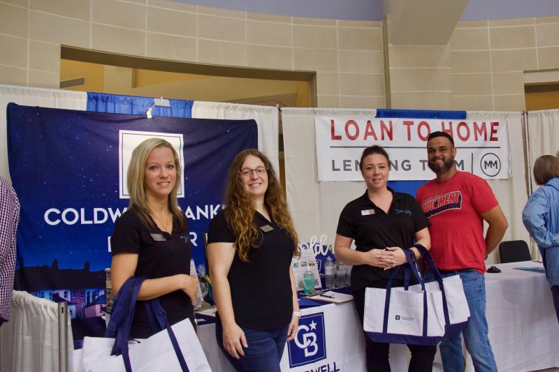 The Julie Gritton team of Coldwell Banker along with Movement Mortgage greets attendees with smiles, goodies and plans to make their dreams of a beach home come true. Shown are (l-r) Melissa Logue, Julie Gritton, Christina Bourdois and Will Southerland.
