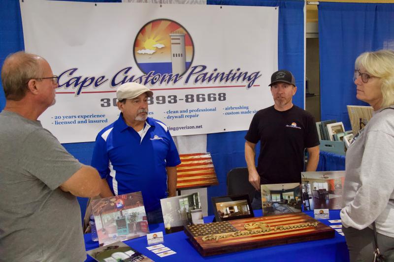Carl Wagner, left, converses with Cape Custom Painting’s Jim Ashley and Ryan Ashley as well as his wife Amanda Wagner. Ryan is the owner and Jim says his son has worked incredibly hard to build the business.