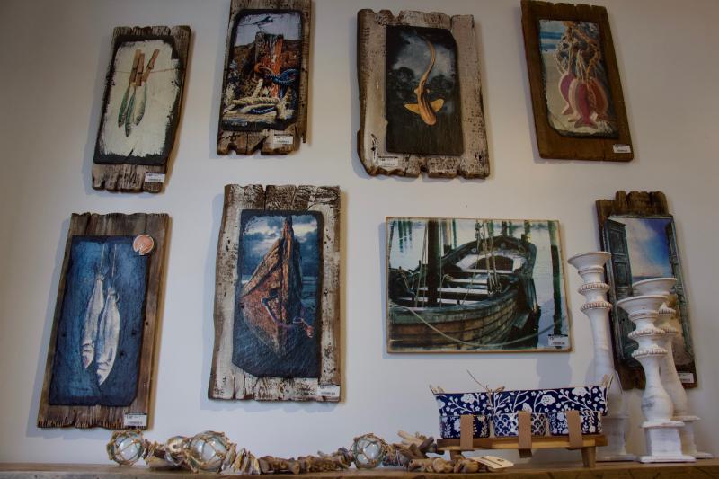 Artwork printed on slate and attached to various pieces of old wood is available for sale, and the process allows for the customer to customize if they have a picture or painting they want on the slate.