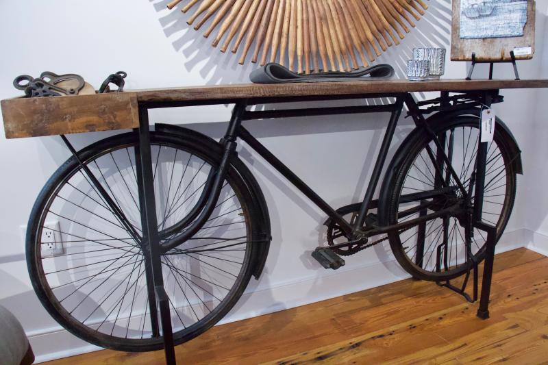 Owner Marty Bueneman’s newest product line incorporates vintage bicycles. Bueneman pointed out the beauty of a restored classic bike and how it does well in the space provided by some tables.