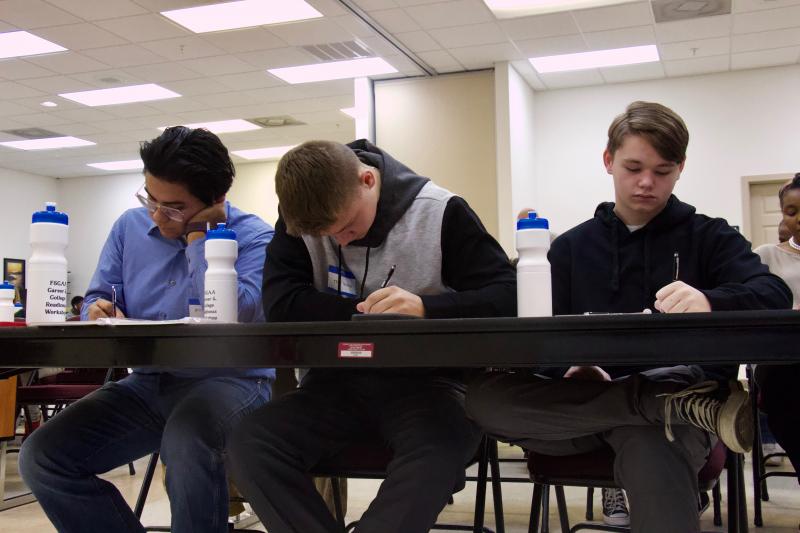 Michael Marquez, Trey Ruark and Trent Ruark concentrate on supplementing their resume using new information provided at the workshop.
