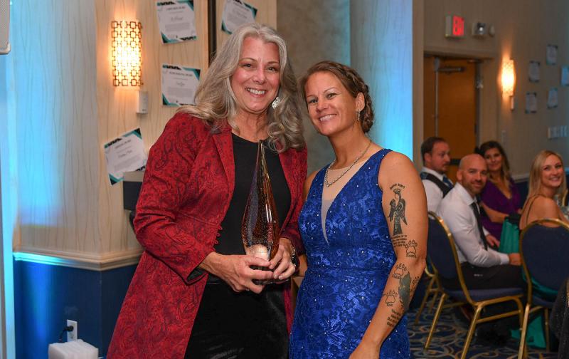 Grass Roots Rescue Executive Director Karli Crenshaw presents Sherri Cook with the 2022 Volunteer of the Year Award.