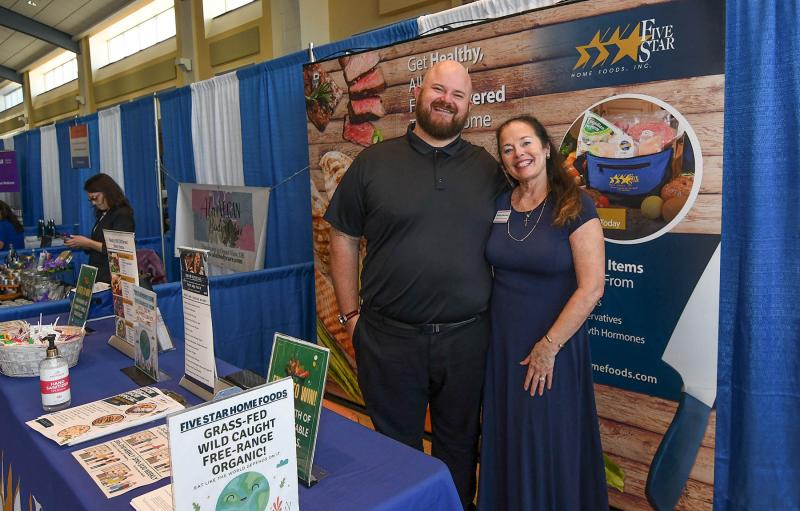 Owner/director of Delaware Resorts Expos Kathy Benson, right, shares a moment with her friend David McClain of Five Star Home Foods.