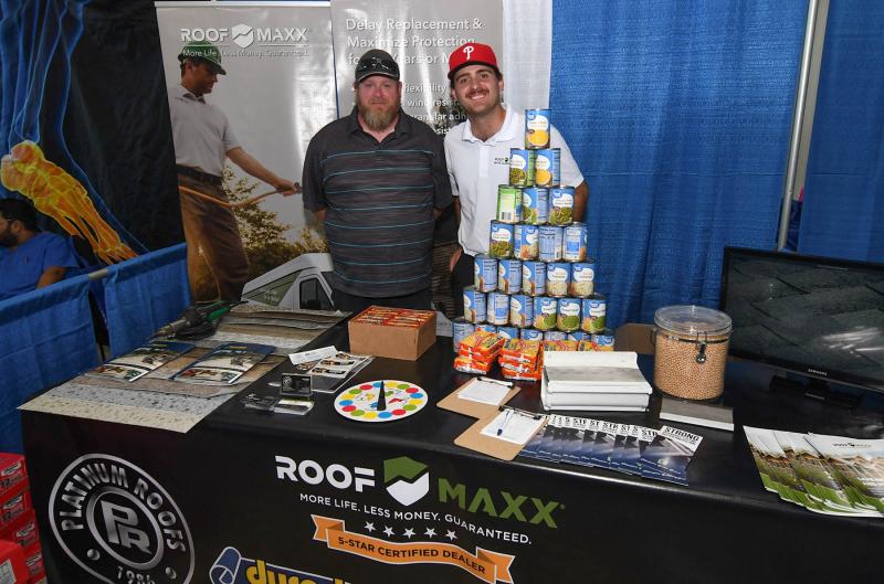 Donating to the food bank and giving information about Roof Maxx are Mike Esposito, left, and Jack Kopko.