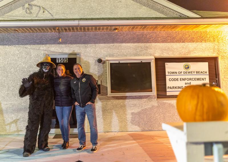 Passing out candy at the Dewey Beach Code Enforcement building are (l-r) a helpful gorilla, Janine DiPaula Stevens and Mayor Bill Stevens.