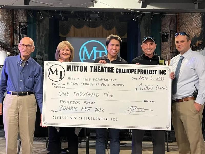 Milton Zombie Fest check presentation attendees shown are (l-r) Milton Community Food Pantry representatives Tom DiOrio and Donna Murawski, president; John Paul Lacap, Milton Theatre marketing director; and Milton Fire Department representatives Chief Johnny Hopkins and President Bryan Reynolds Jr. SUBMITTED PHOTO