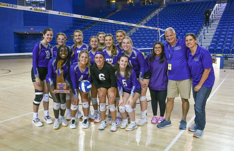 The Delmarva Christian volleyball team celebrates its third-place victory over the Caravel Academy squad. Shown in back are (l-r) Addy Benjamin, Taylor Lowe, Elaina Millaway, Layni Dukes, Keely Kondracki, Maggie Kwiatkowski, Ellie Millaway, Evelyn Jensen, manager Sarah Gardner, head coach Mike Zampini and assistant coach Kim Benjamin. In front are Valencia Mbuagbaw, Tessa Kwiakowski, Lily Fetterman and Tobi Robinson. Missing is Kaylan Yoder. DAN COOK PHOTOS