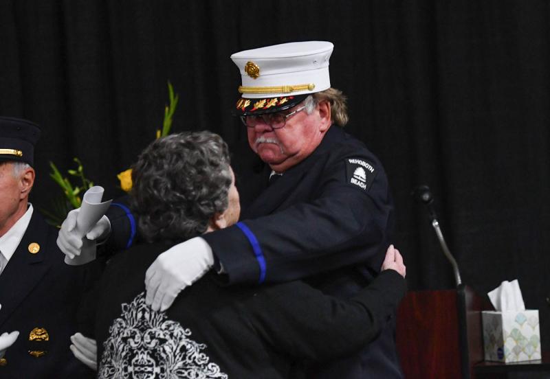 Rehoboth Beach Volunteer Fire Company chief and Mitchell’s good friend Chuck Snyder hugs Danny’s mother Shirley before the service.