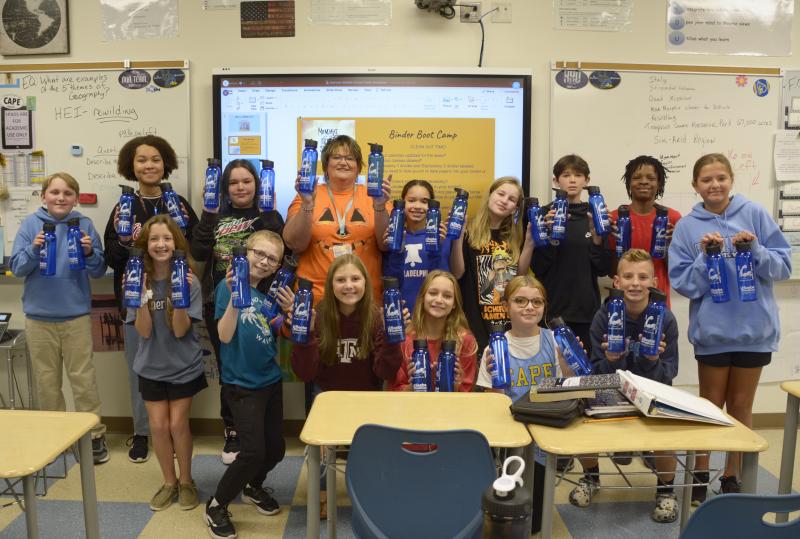 Mariner Middle School showing off the refillable water bottles are in back (l-r) William Waddell Jr., Olivia McCain, Hayleigh Redden, teacher Kay Copp-Moore, Sophia Winkfield, Gabby Fox, Callum Aird, Jamarr Thomas Jr. and Talli Farjon. In front are Elena Kucharik, Matthew Foreman, Riley Windish, Shayne Reynolds, Daisy Hughes and Brayden Green. SUBMITTED PHOTO