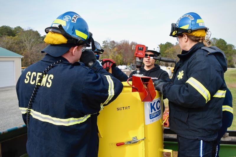Rescue Tech’s Richard Garber, center, gives hands-on training to Sussex County paramedics Trent Hill, left, and Sharon Wile, right, on the proper way to rescue someone covered in grain.