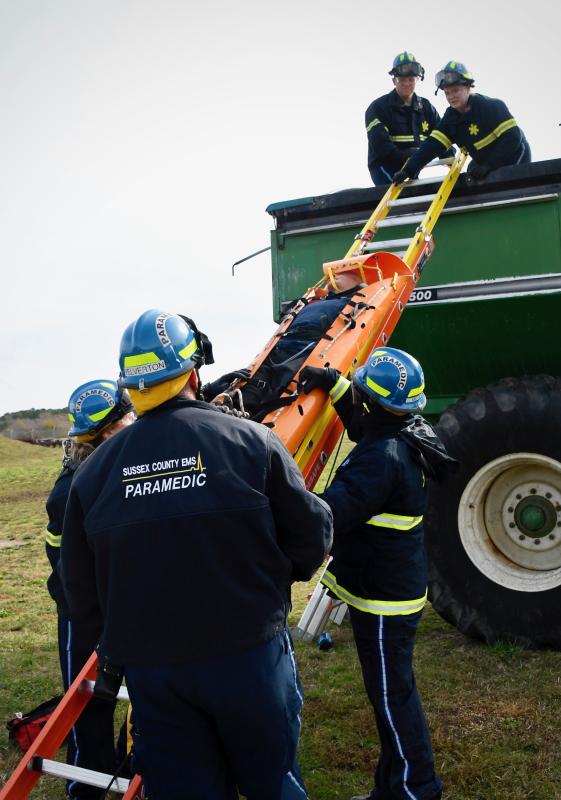 Removing a “victim” from a grain picker accident are paramedics Trent Hill, left, and Courtney Betschner in the bin and on the ground (l-r) Sharon Wile, Calvin Yelverton and Ryan Cook.