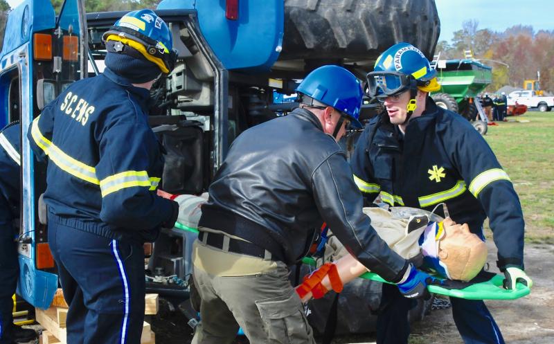 From left, Sussex paramedic Bonnie Allard, DSP aviation unit member Matt Pragg and paramedic Matt Jankovic remove a “victim” from an overturned tractor.