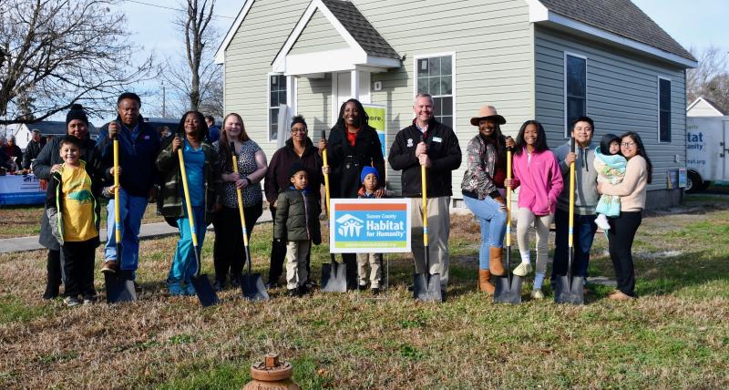 Five of the nine families taking part in the Habitat for Humanity home ownership program attend the Nov. 29 blessing ceremony.