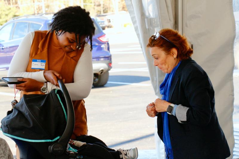 Cierra Dennis, left, brought her 1-year-old baby to the career fair and was greeted instantly by Catherine Vega.