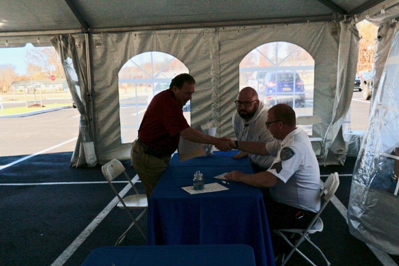 Dennis Eberly shakes hands with Bayhealth Public Safety Officer Kyle Demarsico following a conversation in which Brian Claus also took part. Despite Brian’s last name, it was a job at Bayhealth, not the North Pole.