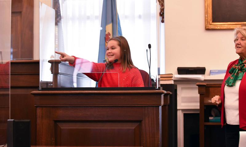 Claire Nagle plays the part of prosecutor Bliss Soucek’s daughter, who testifies that her mom told her that Santa was real. Here she points to the real Santa in the defense chair.