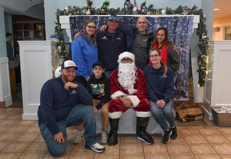 G. Fedale Roofing & Siding volunteers take a picture with Santa. Shown in back are (l-r) Jamie Chaffin, Jeremy Poole, Mike Davis and Ilia Cappello. In front are Chris Shelly, Hayden Weiser, Santa AKA Damien Scala and Emily Boyle.