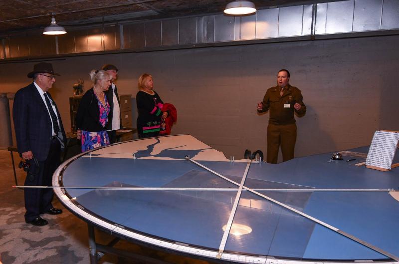 Delaware State Parks interpreter Mark Wilson demonstrates how to track enemy ships in the plotting room.
