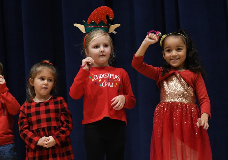 Caylie Walls, Presley Foxx and Kali Wall sing “Rockin’ Around the Christmas Tree” with their Lewes pre-K 3 class.