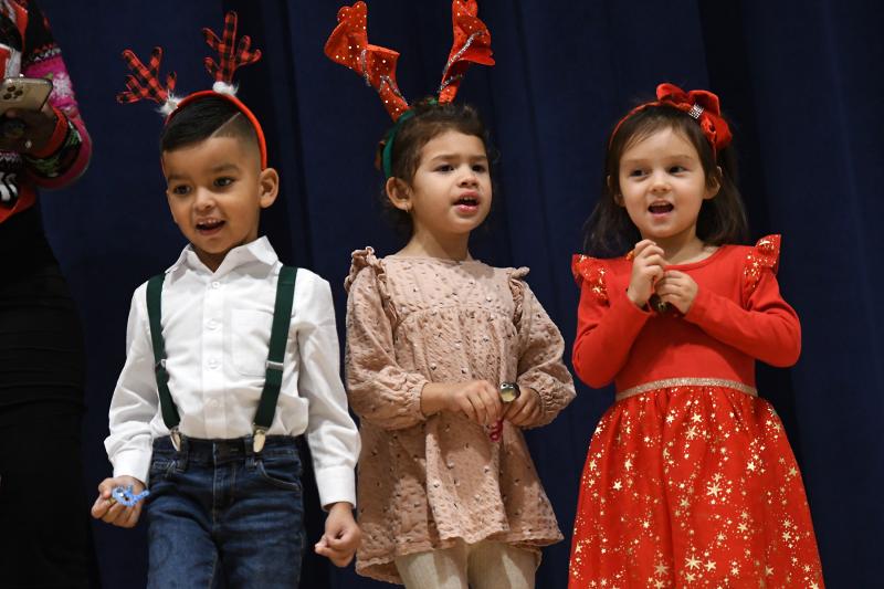 Alejandro Torres, Ariana Nieves and Madeline Rebarchik sing “Santa Claus Is Comin’ to Town” with their Lewes pre-K class.