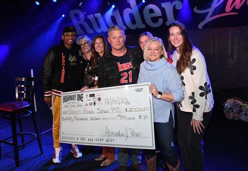 Jimmie Allen and Highway One Companies present a check for $20,000 to Beacon Middle School from the proceeds of two sold-out concerts Dec. 16-17 at the Rusty Rudder and the Bottle & Cork. Shown are (l-r) Allen; Vikki Walls, Highway One promoter; Stephanie Mastrangelo, Beacon PTO president; David Frederick, Beacon principal; Julie Stevenson, Beacon PTO treasurer; Meggin Holtzclaw, Rusty Rudder general manager; and Kelsey Murphy, Highway One artist liaison. DAN COOK PHOTOS