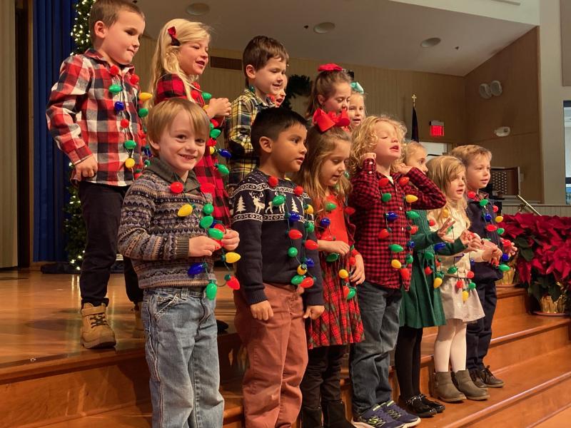 Four-year-olds in the Pelican class, led by teachers Trish McDaniel and Carrie Dare, sing “Christmas Lights.” The class includes in back (l-r) Carson Slavin, Madison Grenert, Boden Stuckey, Elise Sarik and Avery Benson. In front are Dylan Desmond, Jayden DeLeon, Samantha Derrickson, Asa Feindt, Reece Hysler, Amelia Scarano and Cooper Keane.