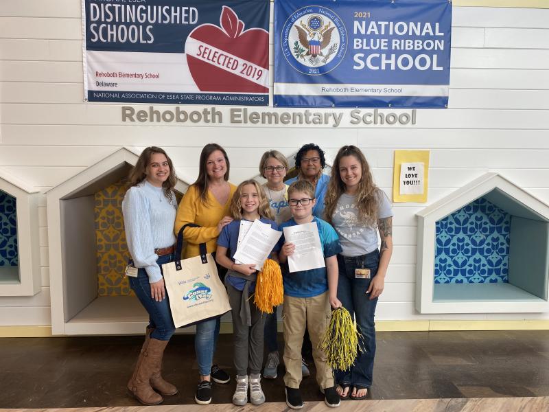 Rehoboth Elementary students Eliza Evans and Zach Day won second place and honorable mention, respectively, in the Coast Day essay contest. Gathered to celebrate the students are in back (l-r) teacher Amy Wilkie, teacher Tina Windsor, teacher Terri Waddell, Principal Doris Person and teacher Alexandra Mueller. In front are Eliza Evans and Zach Day.
