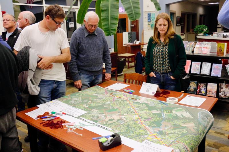 Workshop attendees scoped out maps of bike paths and indicated where they felt the most dangerous parts were, what areas need improvement, and trails/paths they would like to see created. Shown are (l-r) Thaddeus Fisher, Dave Stevenson and Kim Hoey Stevenson.