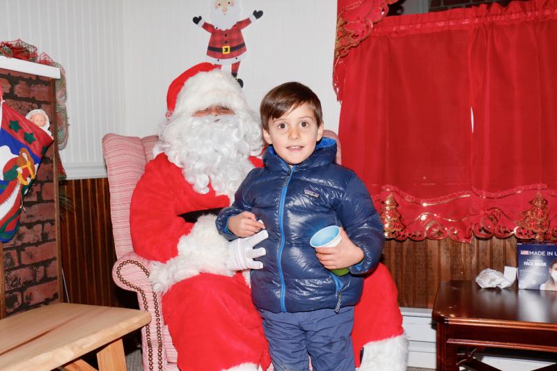 Jake O’Connell, 4, visits Santa on Second Street during Lewes Merchants’ Hospitality Night. Seemingly content with what he has, Jake had to ask his parent, “Wait, what do I want for Christmas?”