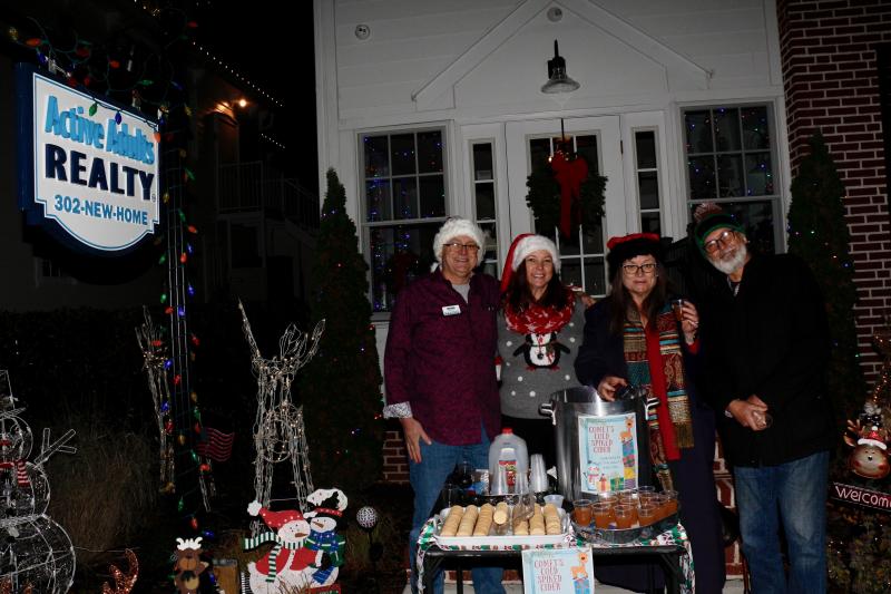Active Adults Realty welcomed folks to its front lawn for great drinks and a chance to take photos with props. Shown are (l-r) Bill Davis, Christine Davis, Leah Troup and Tom Troup.