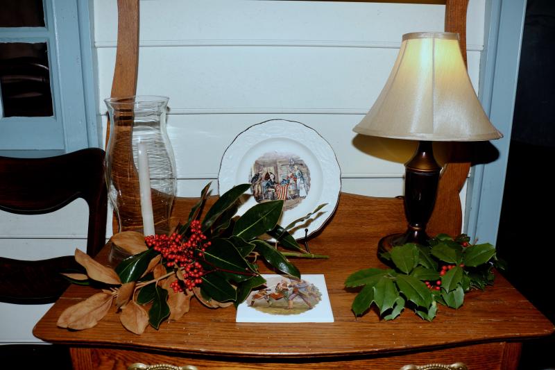 The Maull house, operated by the Daughters of the American Revolution, features various holly and pine tree greenery.