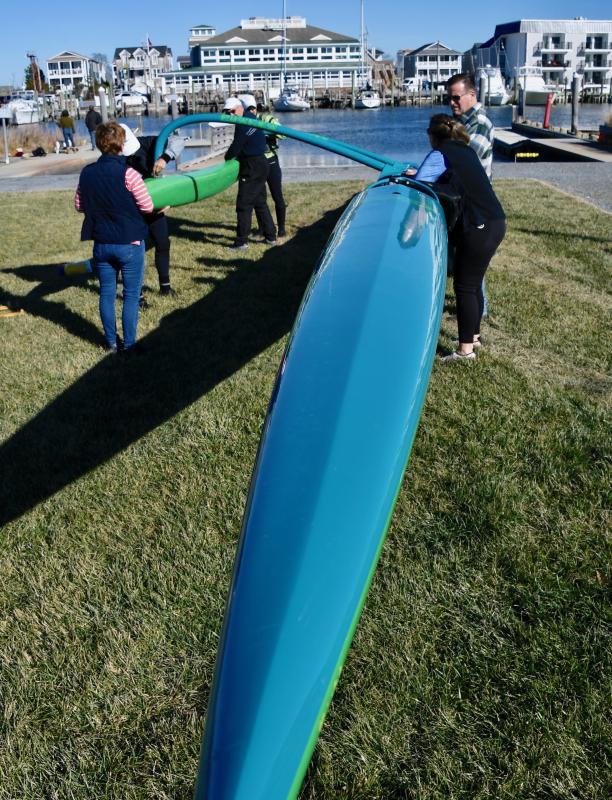New Hope Canoe Club members attach an outrigger to the their canoe before placing it in the chilly waters of the Lewes-Rehoboth Canal.