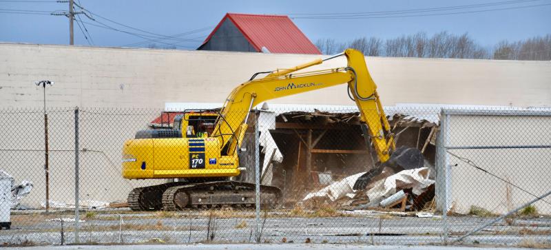 DAY 1. A John Macklin & Son crew is busy at work early Jan. 17 as the demolition of the Bests’ Ace building gets underway.