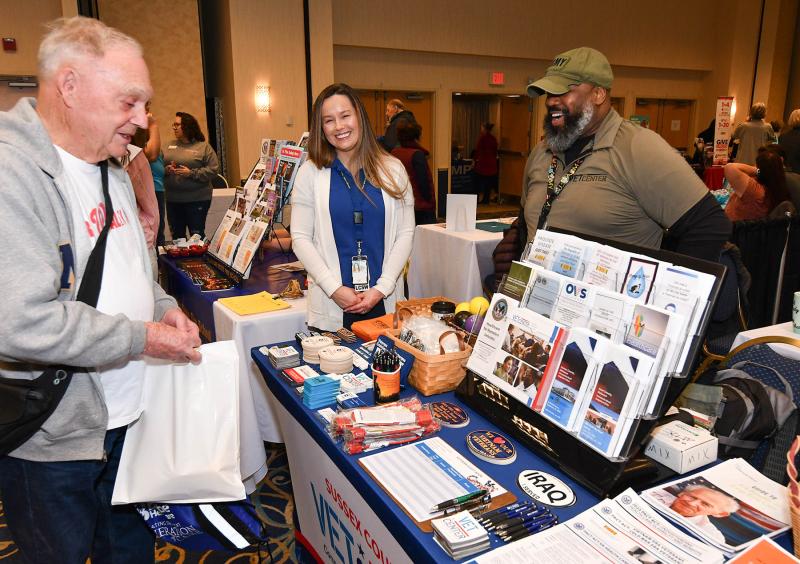 Pete Stout, left, U.S. Navy retired, speaks with April Filiaggi from the Wilmington Veterans Administration Medical Center and Freddy Allen of the Sussex County Vet Center.