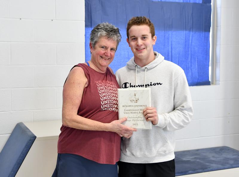 Sussex Academy Aquatics Director Lydia Schmierer presents the Championship Meet Vince Morris Award for the outstanding boys’ performer to Sussex Central’s Breyden Wright.