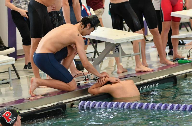 Cape’s Kevin Lewandowski, right, is consoled by teammate Mack Leonhartt after the 200 free relay finals.