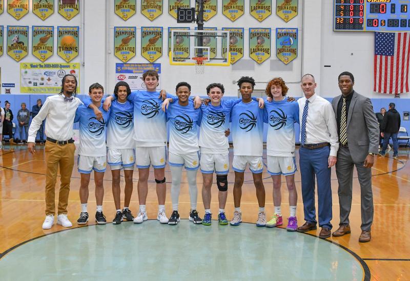 The Cape boys’ basketball Class of 2023 was celebrated before the game with Middletown Feb. 20. Shown are (l-r) assistant coach Kevin Larkin, Timmy Hitchcock, Trey Leggins, Odin Potemski, Tyrone Tolson, Drew Zimmerman, Tajear Freeman, Dylan Fannin, coach Steve Re and assistant coach Josh Hackney. DAN COOK PHOTOS