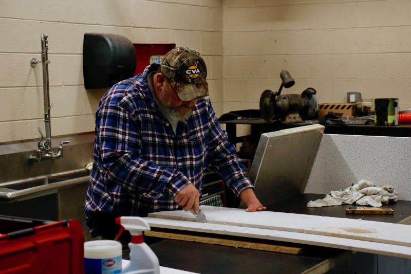 Lewes Fire Department Vice President George Hunsicker Jr. works to repair a ceiling tile. Hunsicker is a generational firefighter and his sons Joshua and Jacob are also members. LFD spokesman Glenn Marshall said that was once common, but it is becoming a rare occurrence these days.