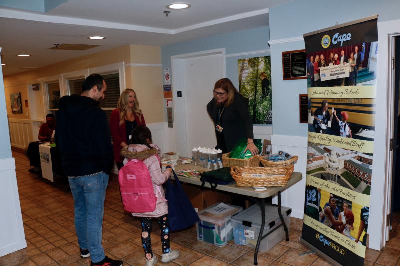 Boyko Boykov and his daughter Veronica Boykov talk to Audrey Carey, back left, supervisor of early learning at Cape Henlopen School District, and Amanda Archambault, supervisor of elementary education.