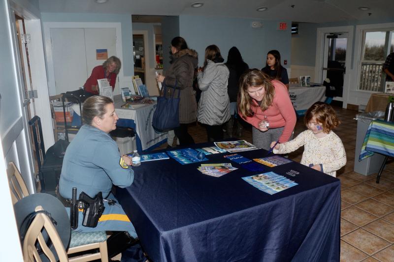 Delaware State Police Cpl. Robin Brown talks to Jessie Roach and her daughter Charlotte about DSP’s community outreach.
