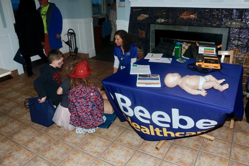 Preston Dunne, Alanah Dunne and Fiona Dunne learn about child and adult CPR from Beebe Healthcare’s Corey Kennedy.