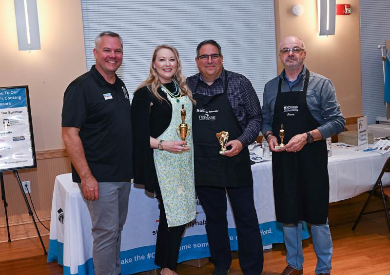 Sussex Habitat CEO Kevin Gilmore (l-r) presents the dessert awards to Cheryl Crowe, first place; Paul Sicari, third place; and Pierre Saez, second place.