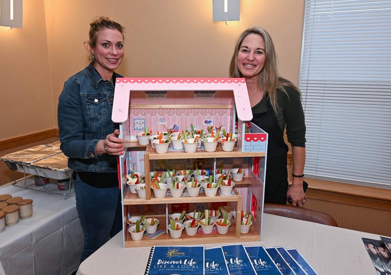 Deniene Daily, right, of Sunrise Real Estate, made a dill dip appetizer. She is assisted by friend Sara Grunsta.