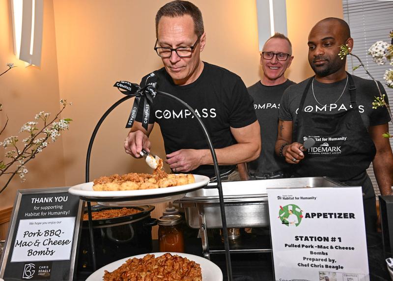 Chris Beagle of The Chris Beagle Group at Compass works on his pork BBQ mac & cheese bombs with his staff, Eric Engelhart and Jason Mathis.
