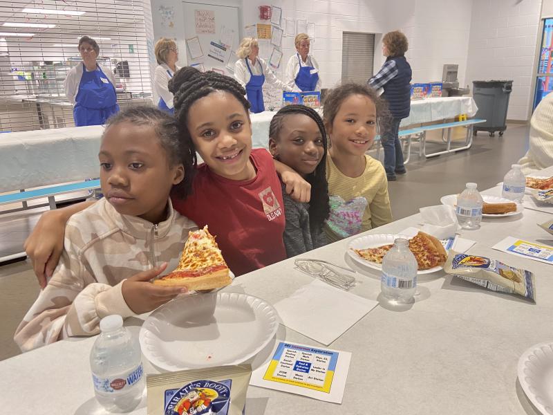 Enjoying pizza in the school cafeteria are students (l-r) Malaia Rodgers, Rayoniah Hood, Te’andra Andrews and Ka’lisa Wapels.